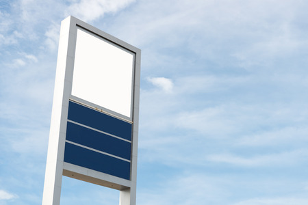 Blank large billboard against cloudy blue skyの写真素材