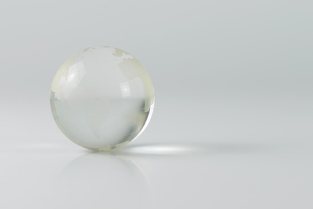 Crystal glass earth globe on grey backgroundの写真素材
