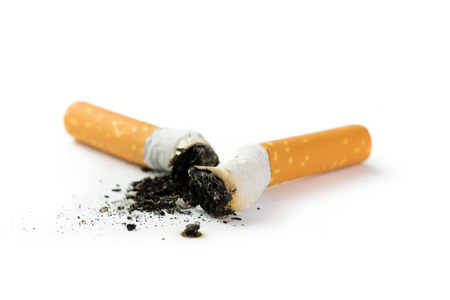 Two cigarette butts with ash isolated on white backgroundの写真素材