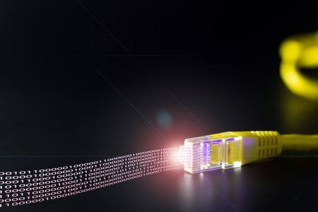 Computer network cable displaying binary data on black background