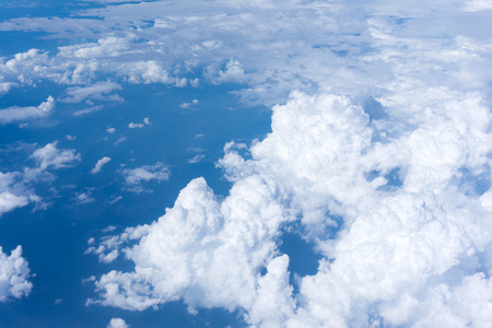 Bright blue sky above puffy white cloudsの写真素材