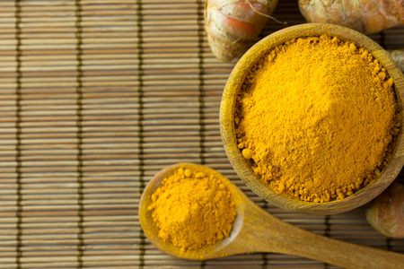 Close up of turmeric powder on bamboo mat