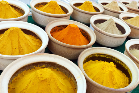 Colorful spices in powder form at the marketの写真素材