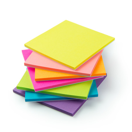 Stack of multicolor sticky note pads on white backgroundの写真素材