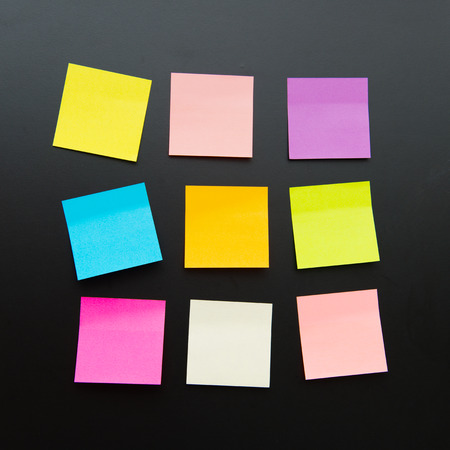 Nine color blank sticky notes on black backgroundの写真素材
