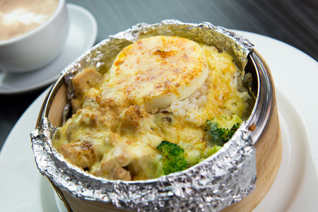 Cheesy baked rice with vegetables and meatの写真素材