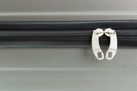 Close up image of a closed suitcase zipperの写真素材