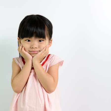 Portrait of little Asian child on white backgroundの写真素材