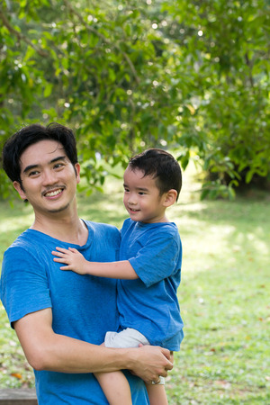 Portrait of father and son in the parkの写真素材