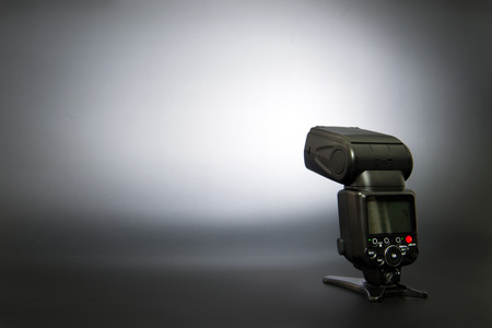 On digital camera flash over black backgroundの写真素材