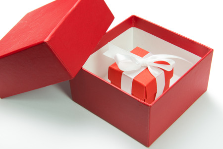 Red gift box with ribbon on white backgroundの写真素材