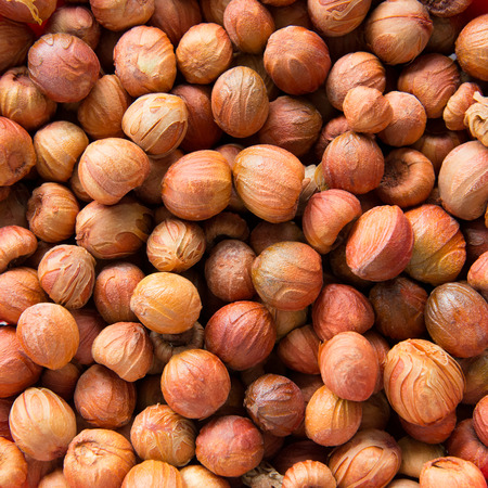 Close up shot of dried nutmeg forming background