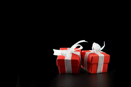 Two red gift boxes isolated on black backgroundの写真素材