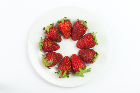 Fresh red strawberries on plate over plate backgroundの写真素材