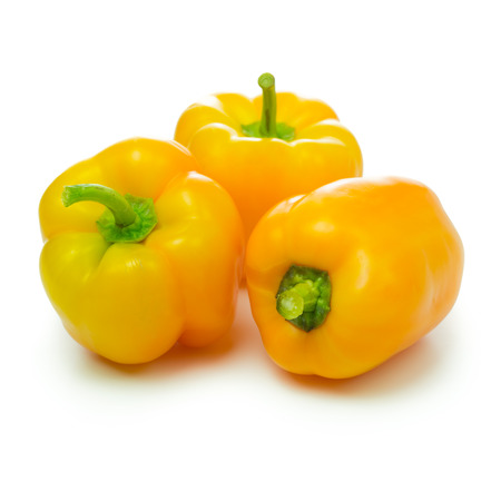 Three yellow capsicums isolated on white backgroundの写真素材