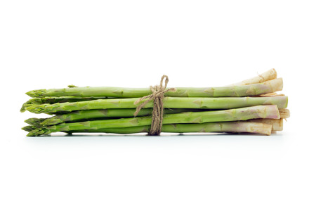 Bundle of fresh asparagus on white backgroundの写真素材