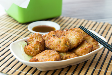 Close up of fried chicken nuggets served on white plate
