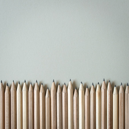 Wooden pencils in a row over white backgroundの写真素材