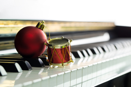 Christmas music illustrated with red Christmas ball on piano keyboardの写真素材