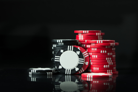 Stacks of poker chips isolated on black backgroundの写真素材