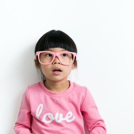 Portrait of little Asian girl on white backgroundの写真素材