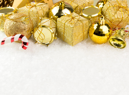 Golden Christmas ornaments on white background, with copy spaceの写真素材