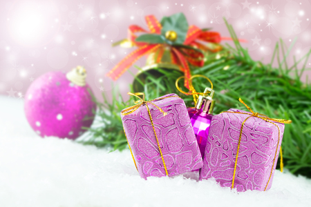 Purple Christmas gifts and ornaments against defocused lights backgroundの写真素材