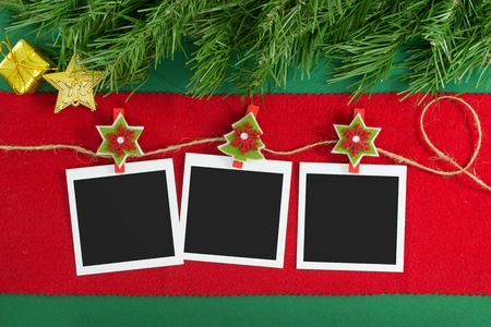 Polaroid photo frames hanging on rope over Christmas backgroundの写真素材