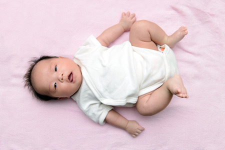Portrait of Asian baby on pink background
