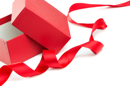 Opened red gift box and satin ribbon on white background, with copy spaceの写真素材