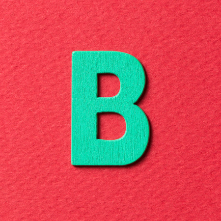 Wooden textured green color alphabet B in red backgroundの写真素材