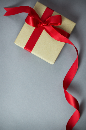 Rustic gift box with red ribbon, with copy spaceの写真素材