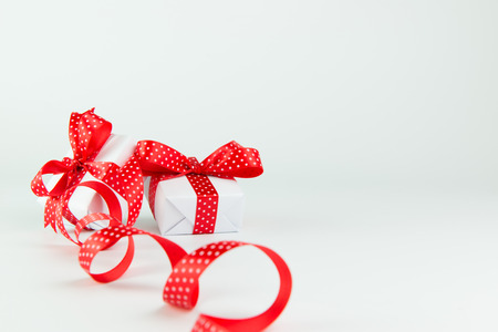 Gifts wrapped with red ribbon and bow, with copy spaceの写真素材