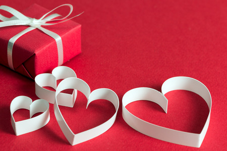Red gift box with heart shape symbol for Valentines or wedding themeの写真素材