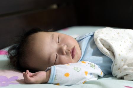 Asian little baby boy is sleeping peacefullyの写真素材
