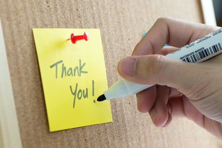 Thank you yellow note on cork notice boardの写真素材