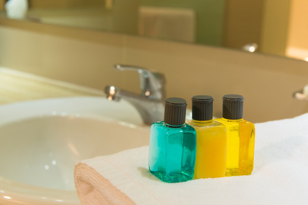 Toiletries on towel in a hotel bathroomの写真素材