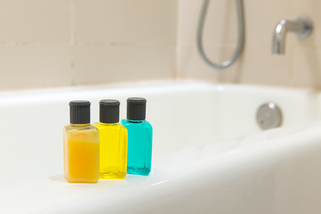 Set of toiletries on bathtub in a hotel bathroomの写真素材