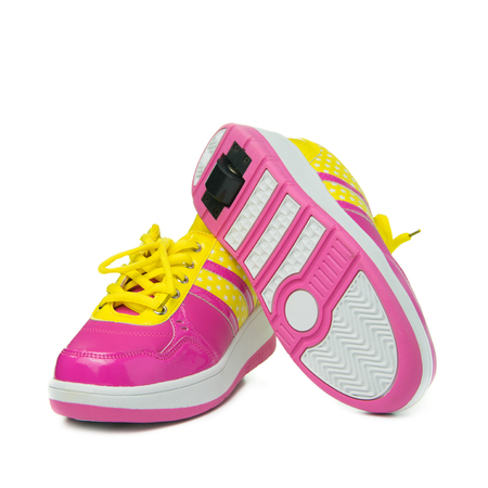 Pair of pink heelys on white backgroundの写真素材