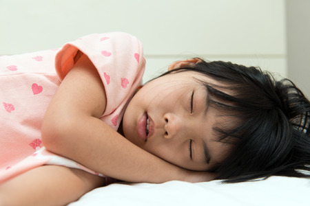 Close up of little Asian girl sleeping soundlyの写真素材