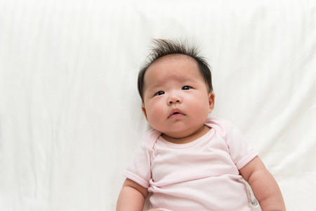 Portrait of Asian baby girl on white backgroundの写真素材