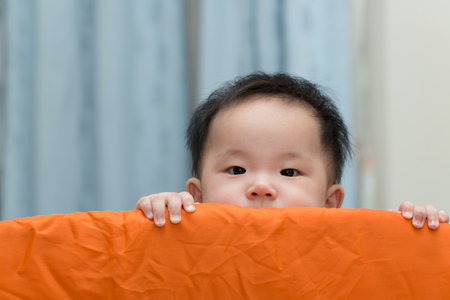 Portrait of an asian baby in playpenの写真素材