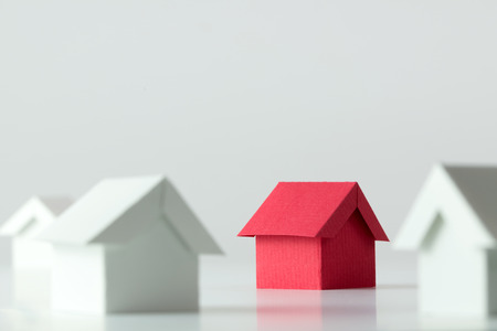 Red house in among white houses for real estate property industryの写真素材