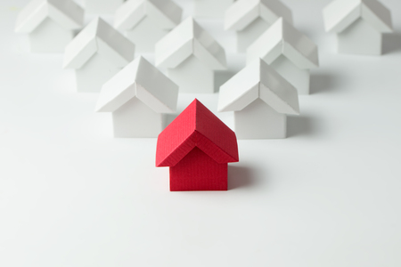 Red house in among white houses for real estate property industryの写真素材
