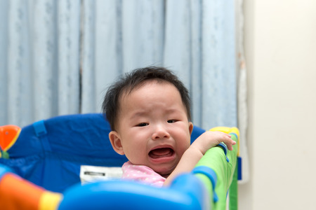Portrait of an asian baby in playpenの写真素材