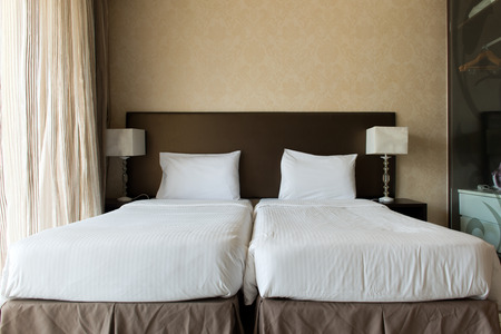 Interior of hotel bedroom with twin beds putting togetherの写真素材