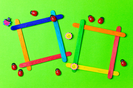 Ice cream sticks photos frames over green backgroundの写真素材