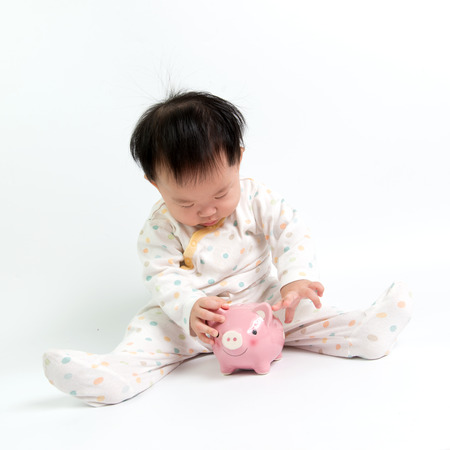 Portrait of Asian baby with piggy bankの写真素材