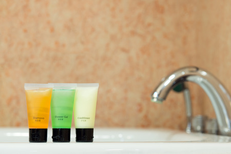 Set of toiletries placed at sink in the bathroomの写真素材