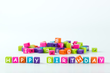 Happy Birthday word spelled with colourful wooden blockの写真素材
